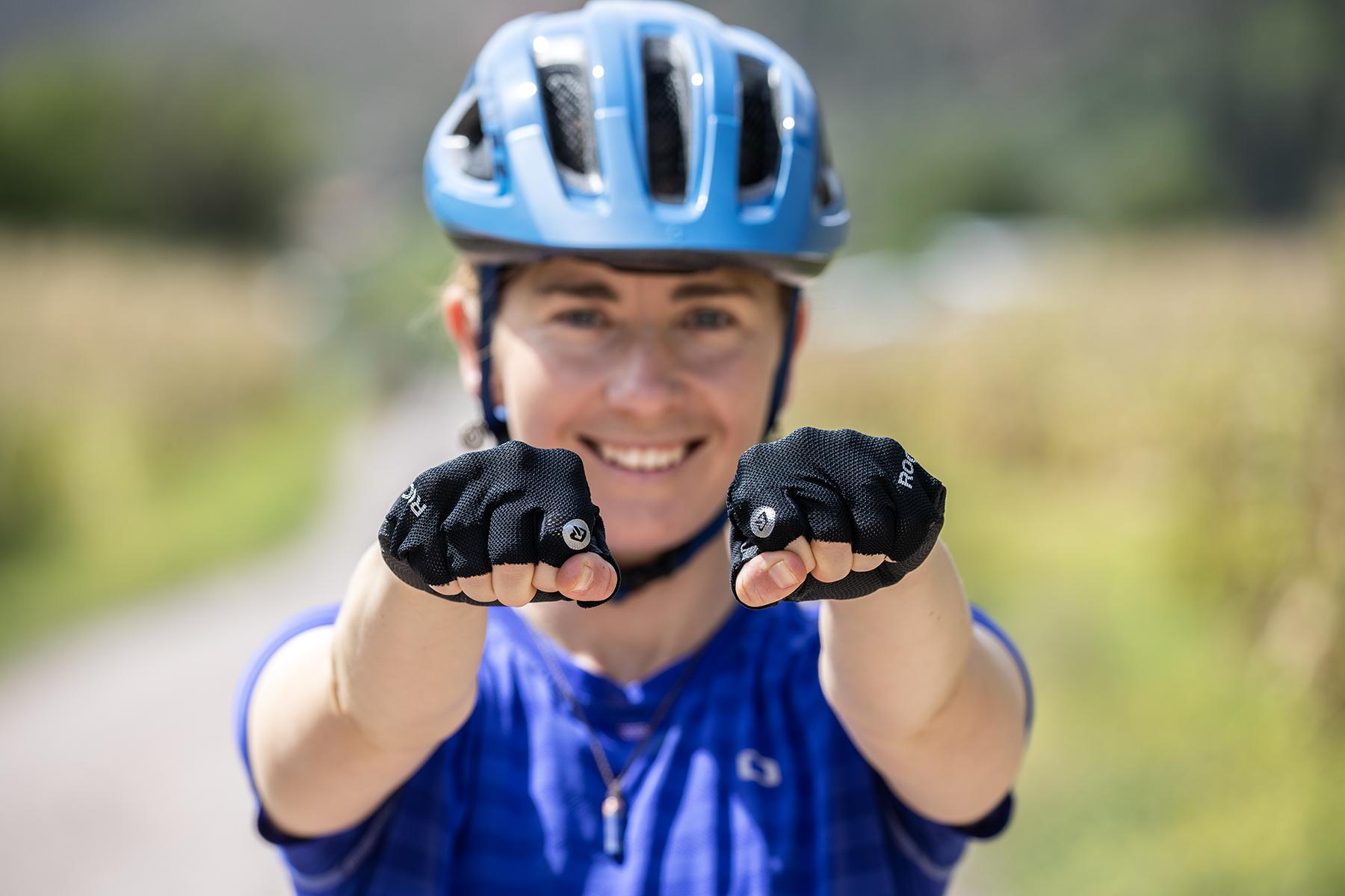 A female cyclist tries on her protective equipment and prepares to enjoy a group mountain bike tour in Cusco